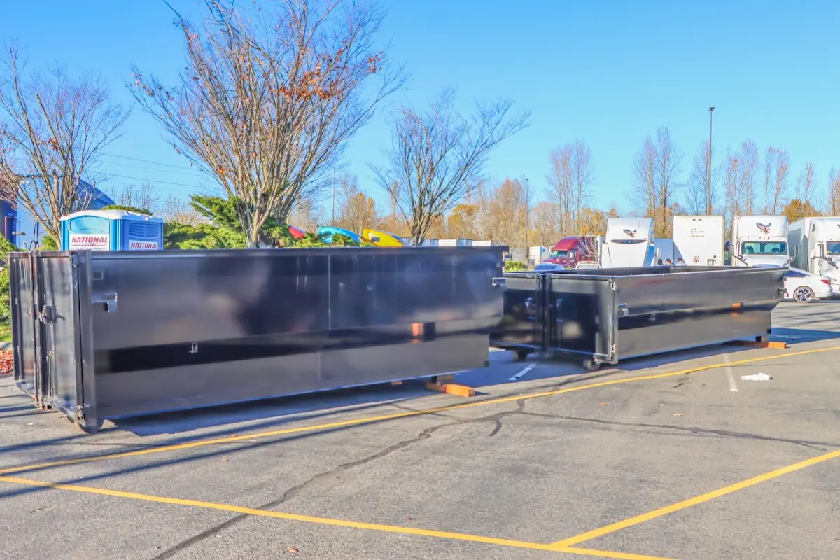 Professional dumpster rental service with roll-off container on residential driveway in Danville